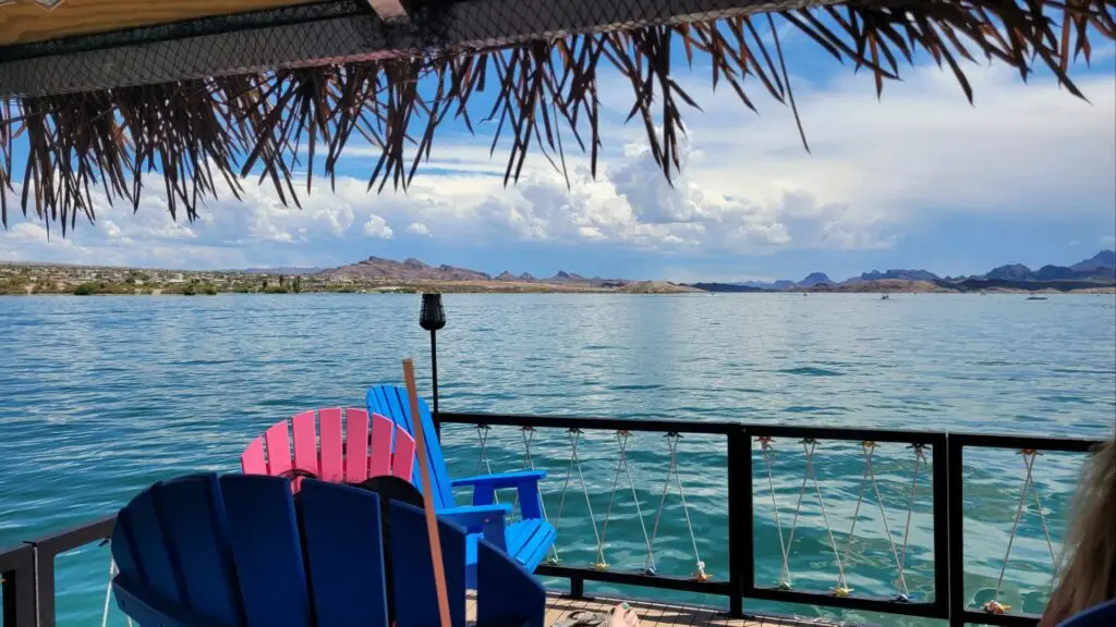 a deck with chairs on it overlooking a body of water - Boat Rental
